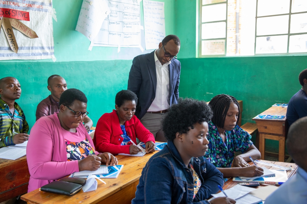 Gasapard Twagirayezu, the Minister of State for Primary and Secondary education inspects how teachers are trained during the launch of the training at Ecole Des Sciences de Musanze. Photos by Willy Mucyo