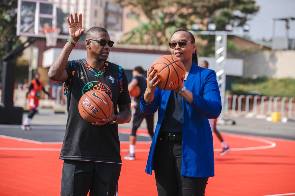 (L-R) Ujiri and Minister Mimosa Munyangaju at a basketball court Photo By Willy Mucyo