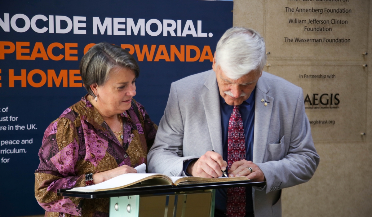 Lt Gen (rtd) Romeo Dallaire writes his message in the visitors&#039; book at Kigali Genocide Memorial as his wife Marie Michaud looks on. Photos by Craish Bahizi