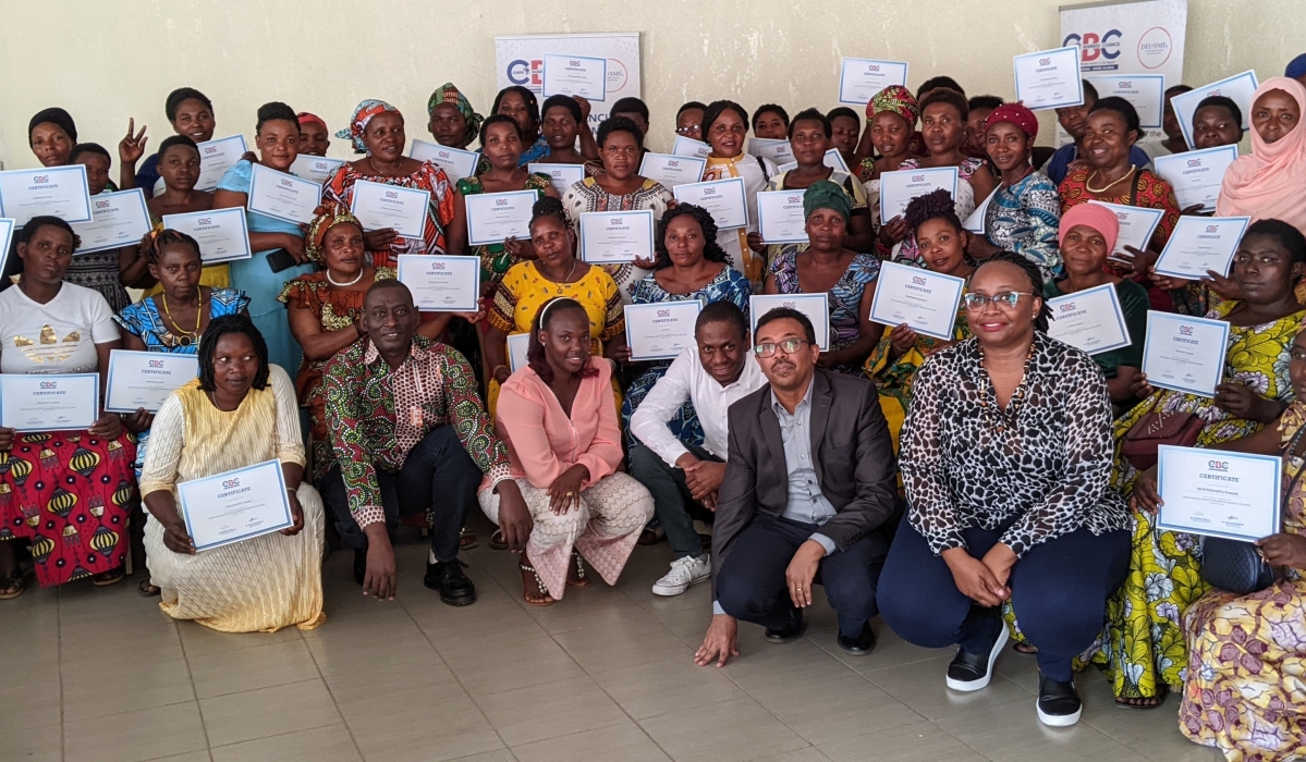 Participants  pose for a group photo with their certificates after completing a three-day training on how to embrace digital payment as part of their daily business. Photos by Germain Nsanzimana 
