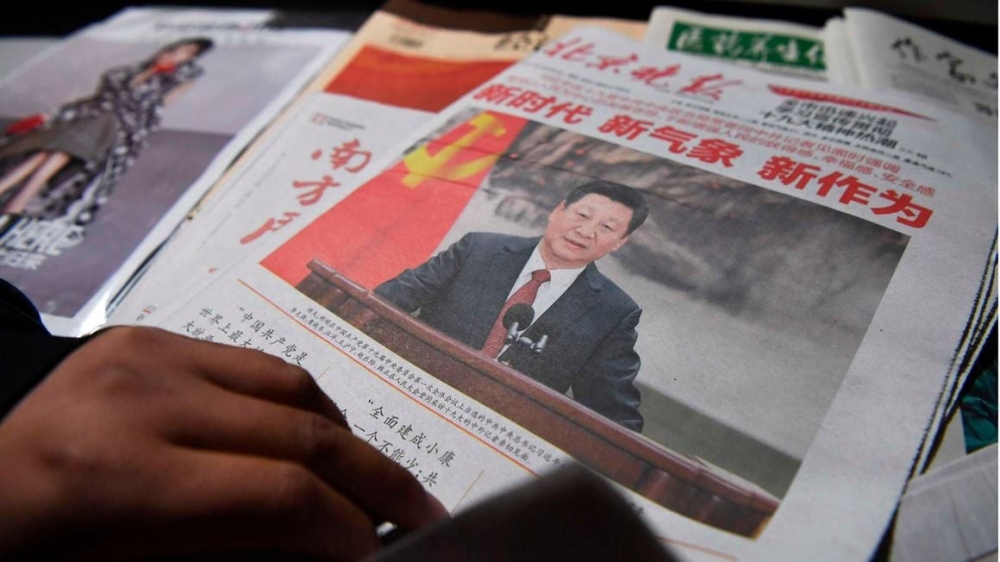 A newspaper featuring Chinese President Xi Jinping at a news stand in Beijing, China. PHOTO _ GREG BAKER _ AFP