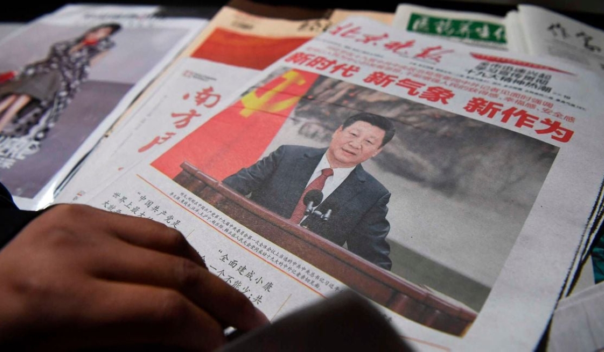A newspaper featuring Chinese President Xi Jinping at a news stand in Beijing, China. PHOTO _ GREG BAKER _ AFP