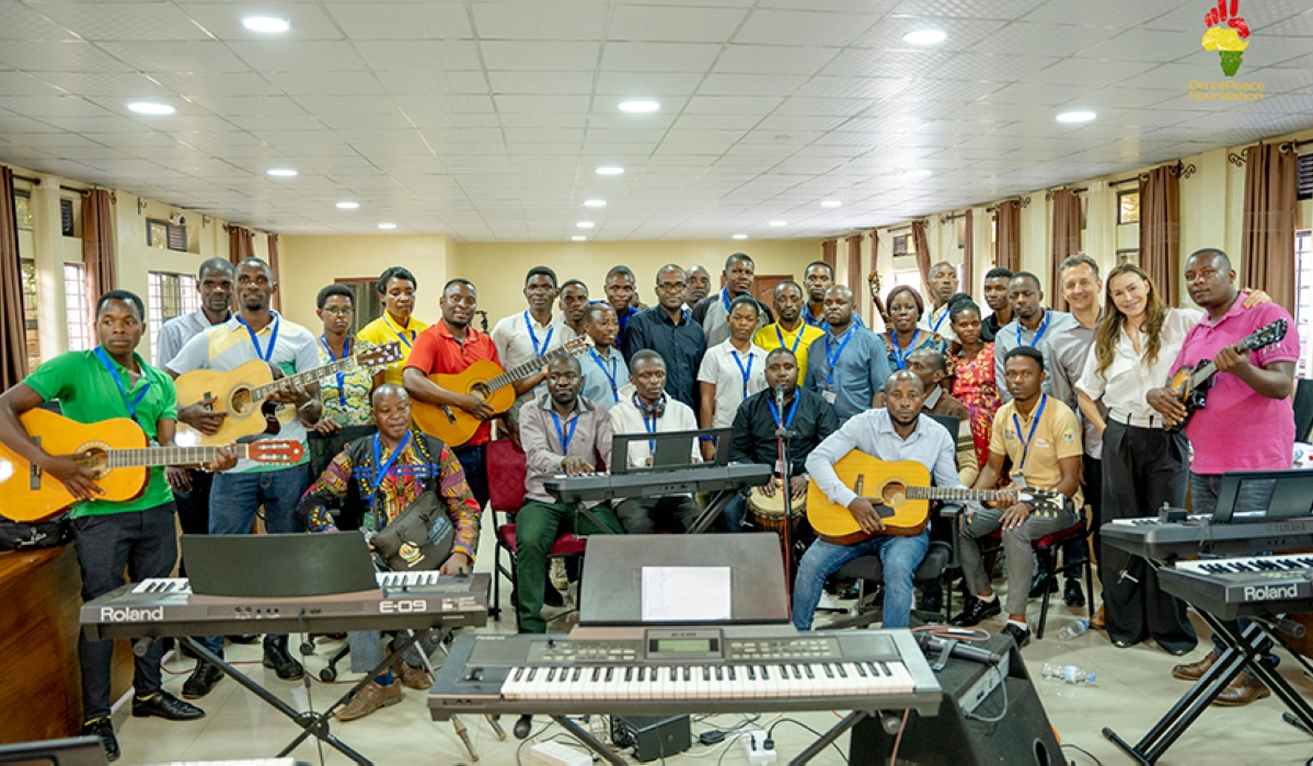 The music teachers who are being trained pose for a photo with Dr Richard Carrick, Chair of Music Composition at Berklee College of Music and Mary Fanaro, CEO Founder OmniPeace Foundation.