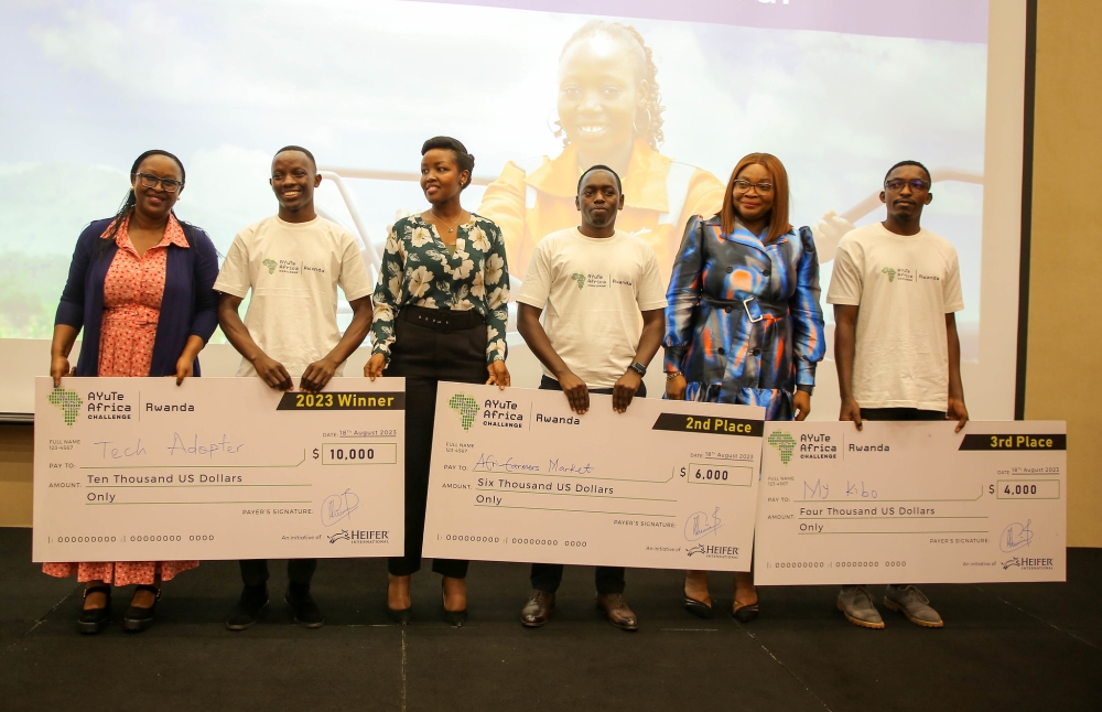 Minister of ICT Paula Ingabire (c) in a photo with winners as Heifer International Rwanda honored three exceptional young agri-tech innovators in Rwanda on Friday, August 18. All Photos by Craish Bahizi