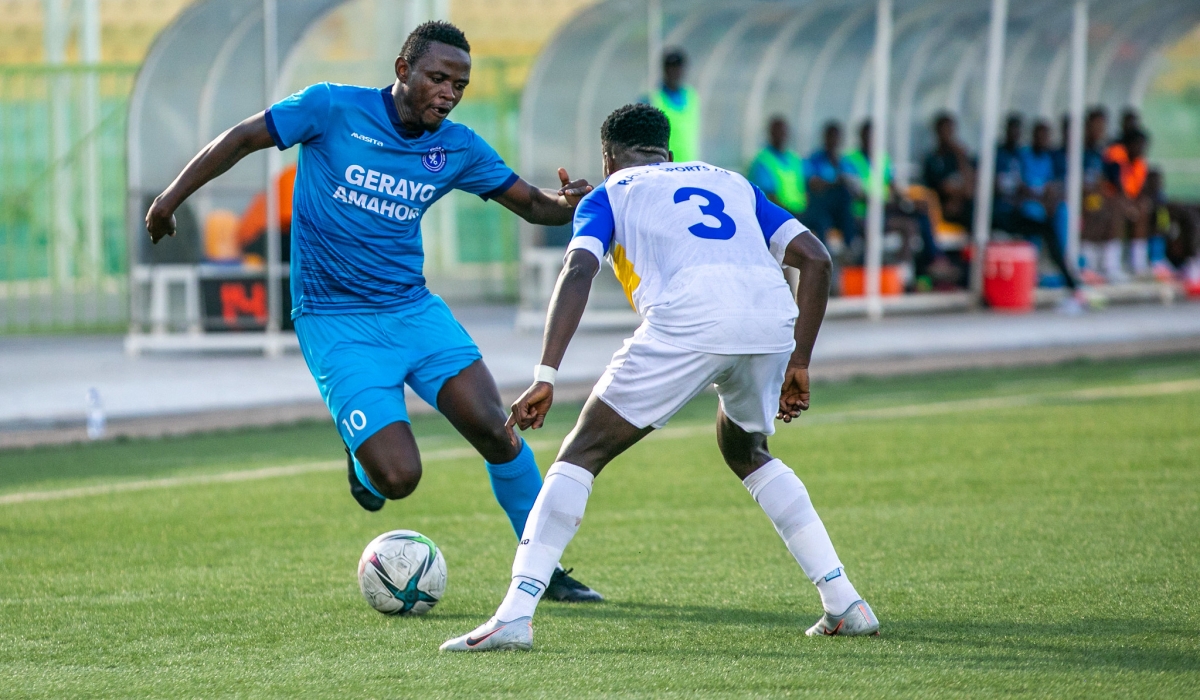 Forward Muhadjiri Hakizimana tries to go past Rayon Sports&#039; player during a league game. . Olivier Mugwiza