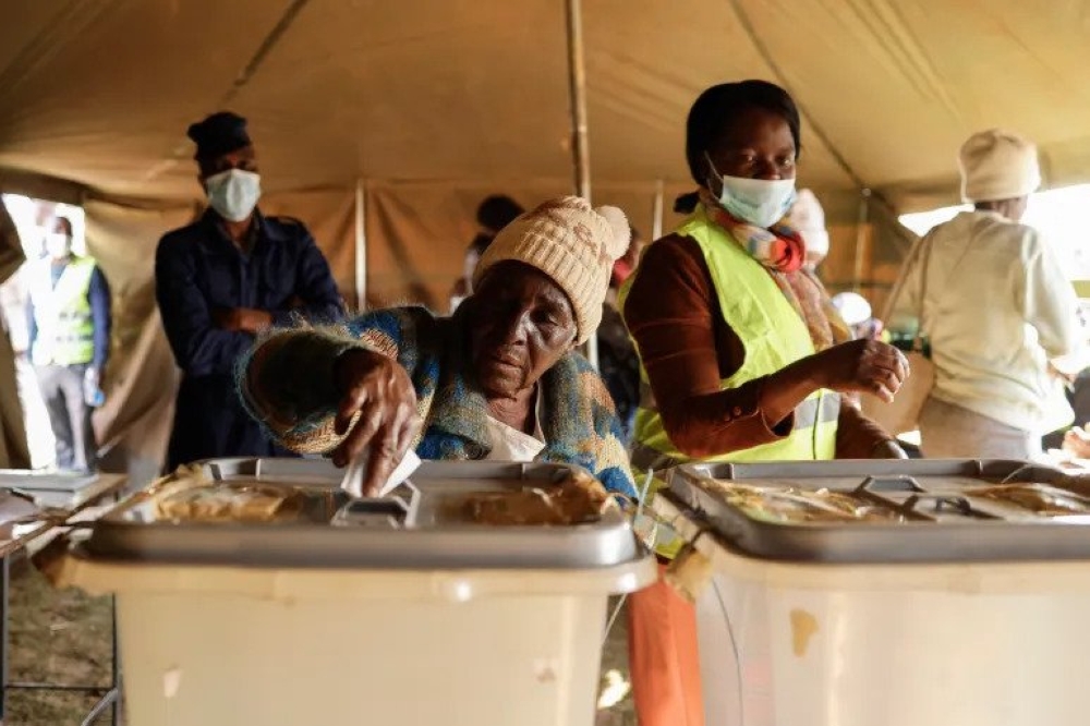 A woman casts her ballot at a polling station in Mbare, Harare [John Wessels - AFP]