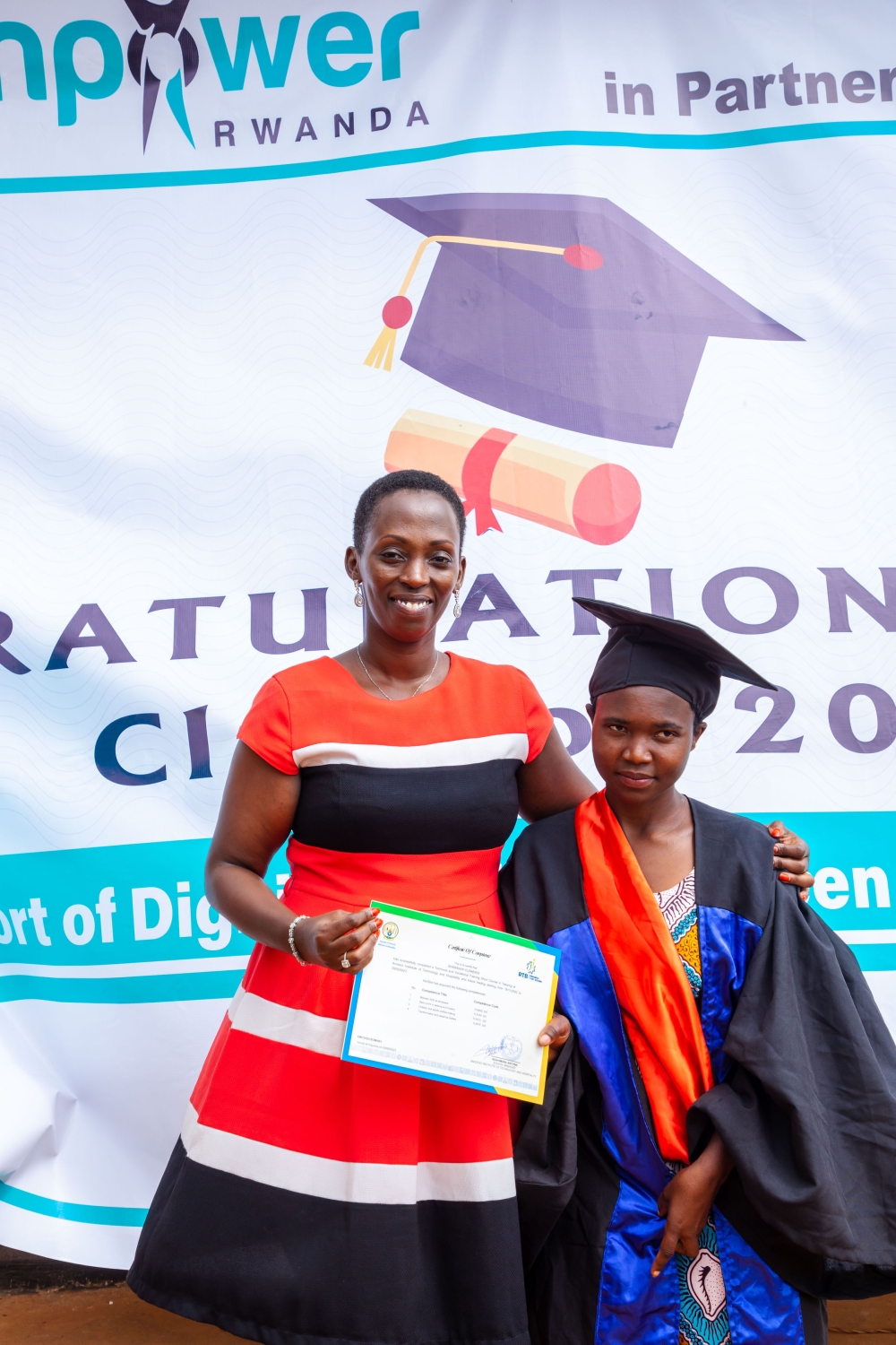 Empower Rwanda&#039;s founder and country director, Olivia Promise Kabatesi, presents a certificate to oneof 100 graduatesat the ceremony in Gatsibo
