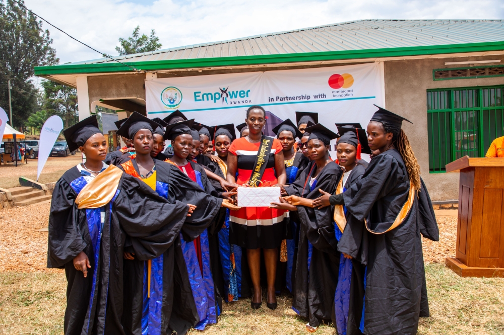 Some of the graduates present a gift to Olivia Promise Kabatesi, founder and country director of Empower Rwanda, in recognition of her efforts at the ceremony Some of the graduates present a gift to Olivia Promise Kabatesi, founder and country director of Empower Rwanda, in recognition of her efforts at the ceremony
