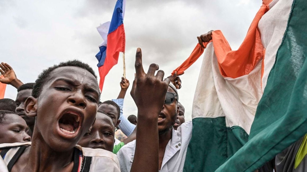 Supporters of National Council for the Safeguard of the Homeland wave the Russian and Nigerien flags as they gather for a demonstration in Niamey, Niger near a French airbase on August 11, 2023. PHOTO | AFP