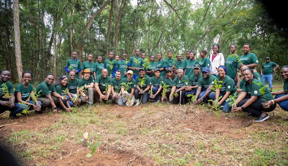 Participants pose for a photo during a  tree planting exercise at Ruhande Arboretum in Huye District,on March 11. File
