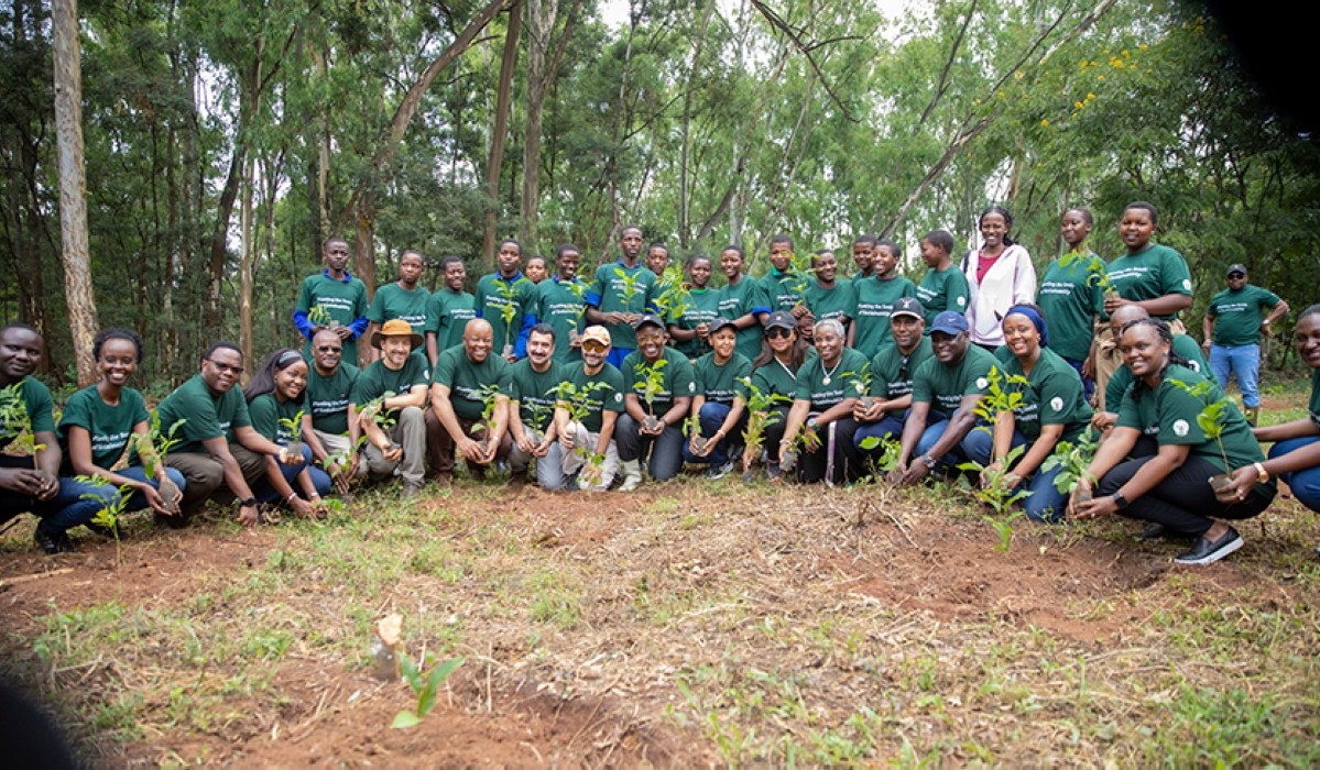 Participants pose for a photo during a  tree planting exercise at Ruhande Arboretum in Huye District,on March 11. File