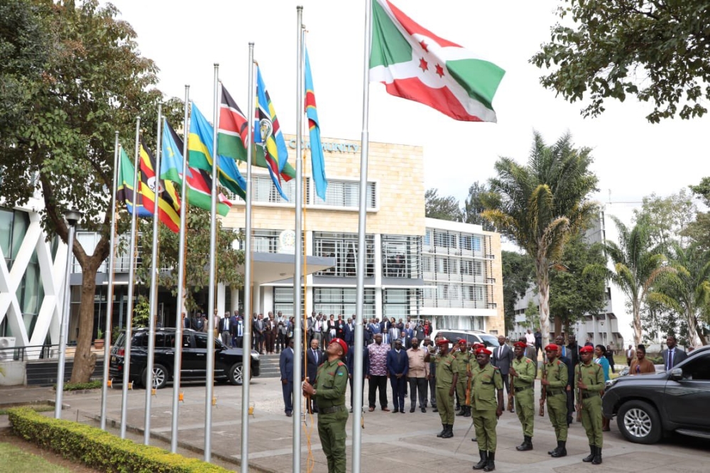 Officers hoist EAC flags during event at the East African Community headquarters  in Arusha on July 11.Courtesy