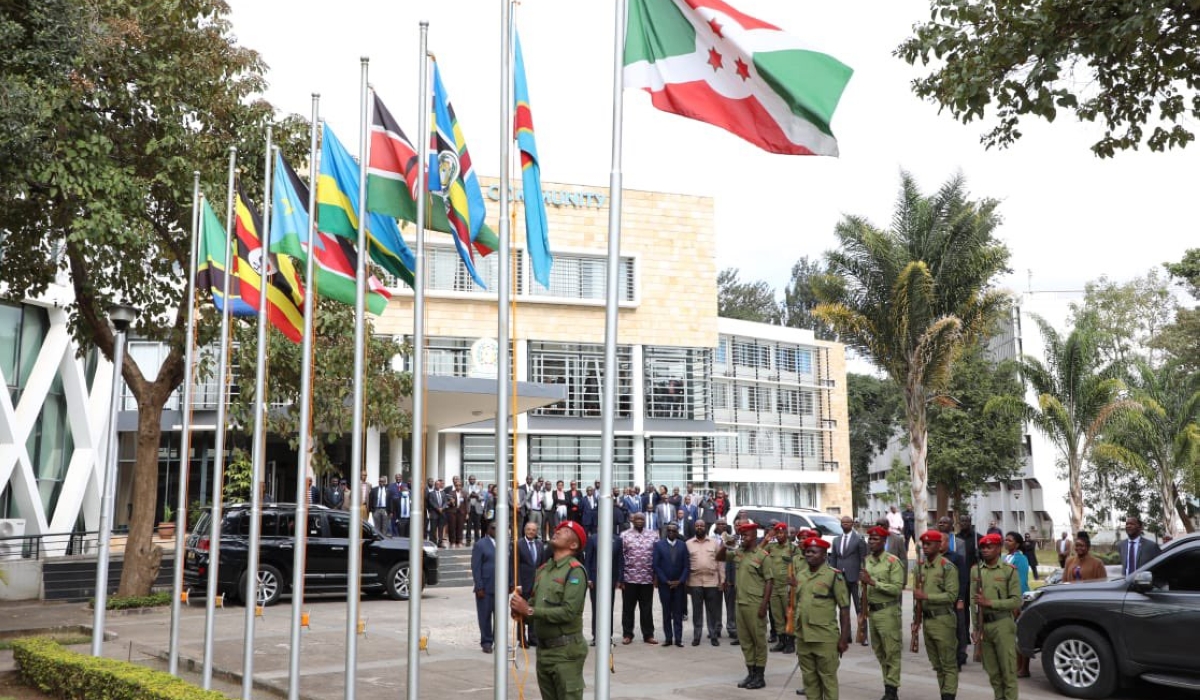 Officers hoist EAC flags during event at the East African Community headquarters  in Arusha on July 11.Courtesy