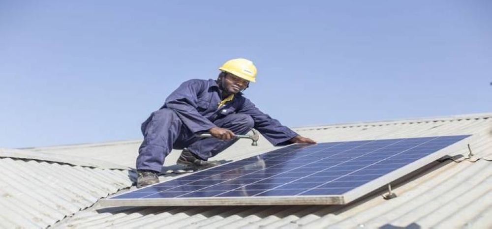 A technician during an installation of a solar panel. The government has revised the National Electrification Plan  to augment the number of households connected to the national grid and bolster off-grid solutio 