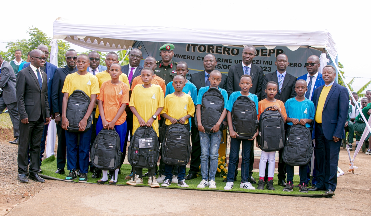 The best performer-students in a test prepared by ADEPR Church for its schools pose for a photo with officials, after being awarded with school materials and fees for the next academic year. (ADEPR)