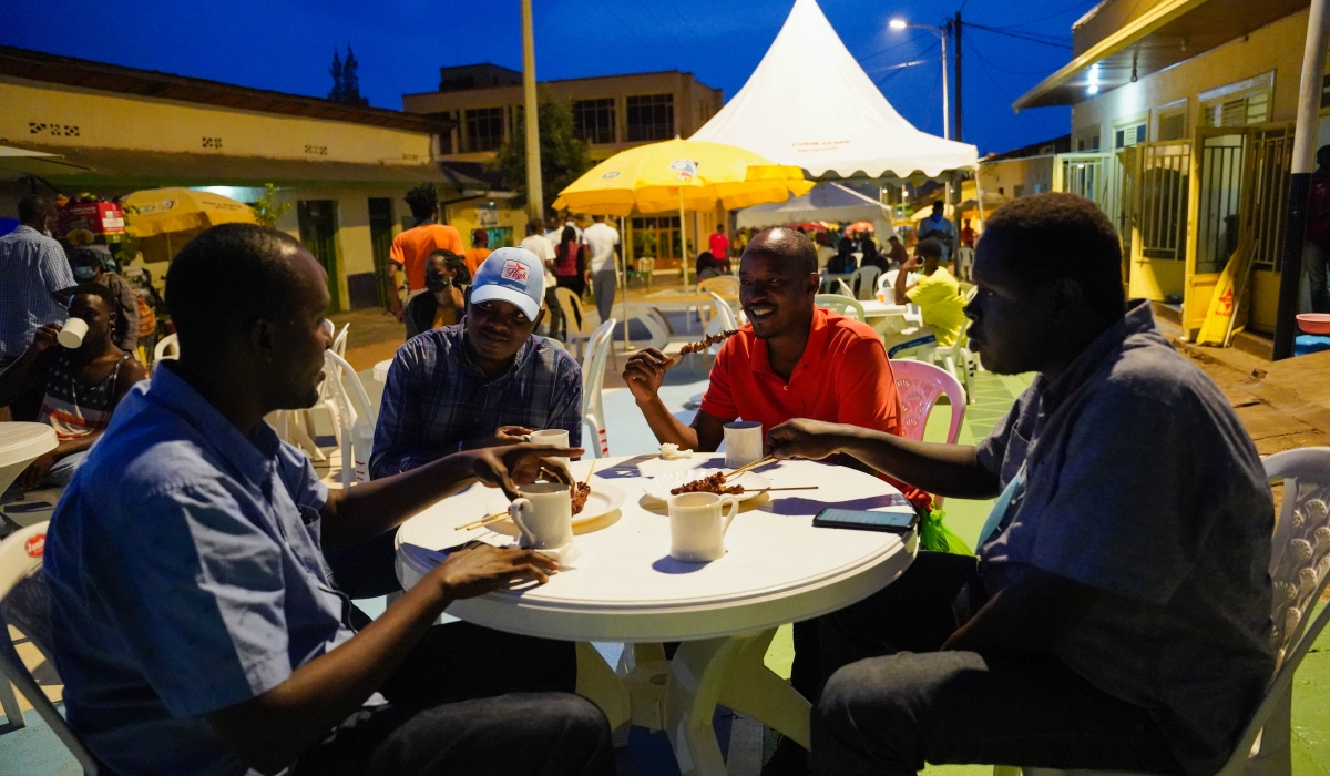 Clients take green tea at Biryogo Car Free Zone.  Commercial entertainment venues such as restaurants, bars, nightclubs, and liquor stores must close at 100 am from Monday to Friday and at 200 am on Saturday and Sunday. Craish Bahizi