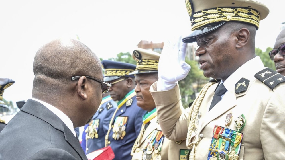 Head of Gabon&#039;s elite Republican Guard, General Brice Oligui Nguema (R), is decorated by Gabon Prime Minister Alain Claude Bilie Bie Nze (L) in Libreville on August 16, 2023 during celebrations ahead of Gabon Independence day celebrated on August 17, 2023. (Photo by - / AFP)