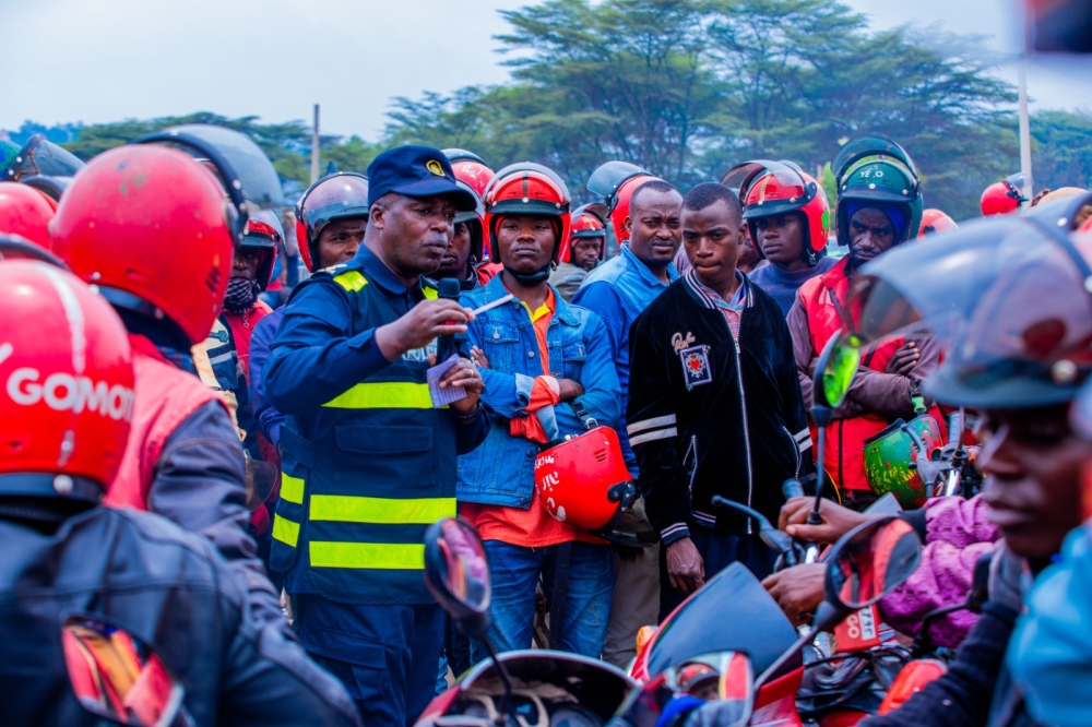 SSP Rene Irere interacting with taxi-moto operators in Kigali during a road safety awareness