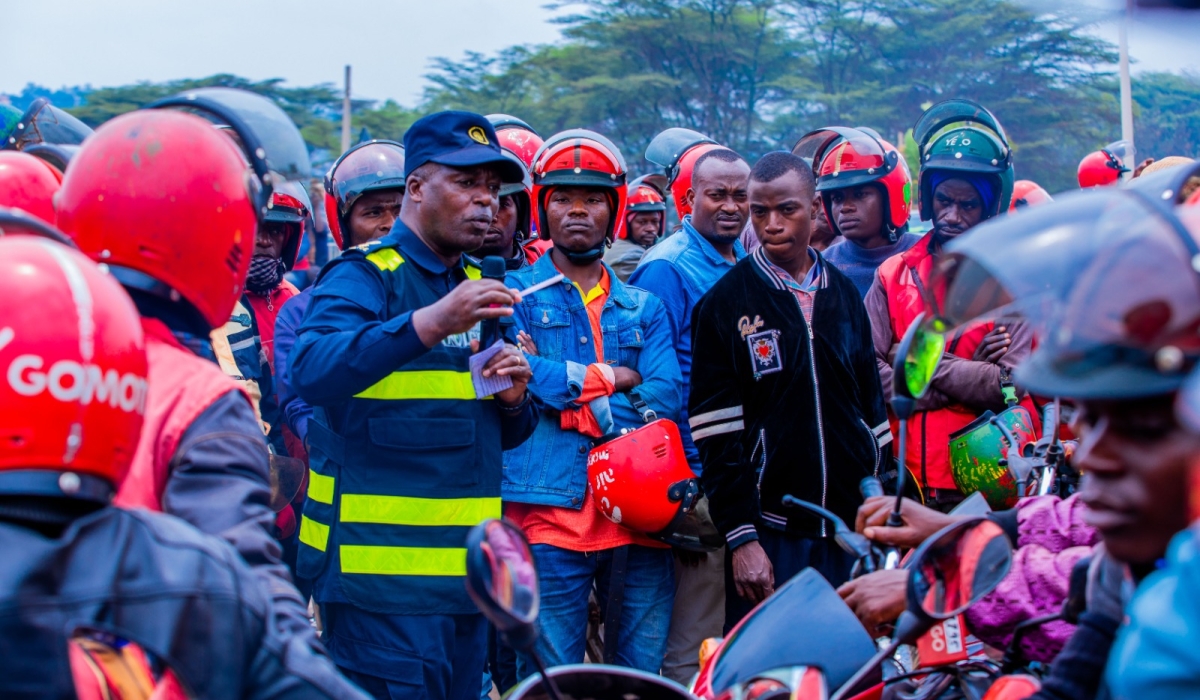 SSP Rene Irere interacting with taxi-moto operators in Kigali during a road safety awareness