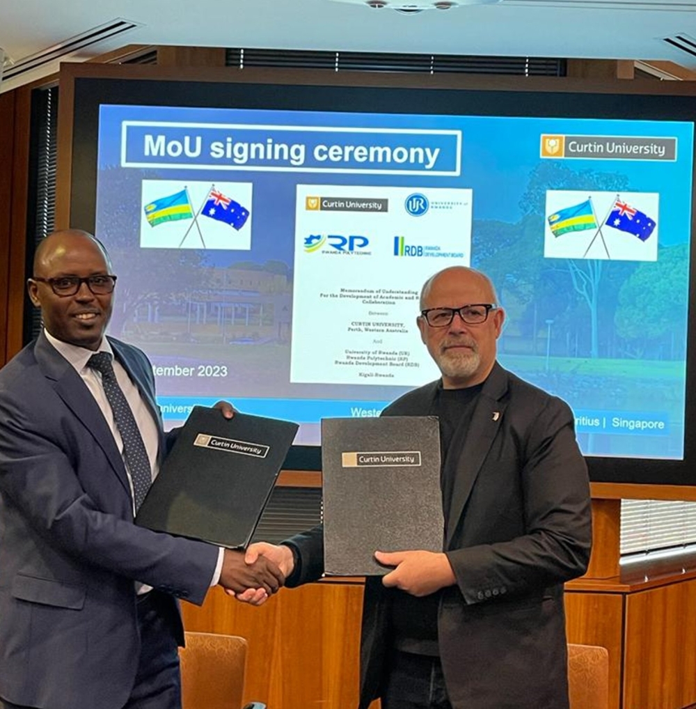UR Vice Chancellor Prof. Didas M. Kayihura  and Deputy Vice Chancellor, Global, at Curtin College Prof. Seth Kunin exchange documents after signing a Memorandum of Understanding on Tuesday, September 5. Courtesy
