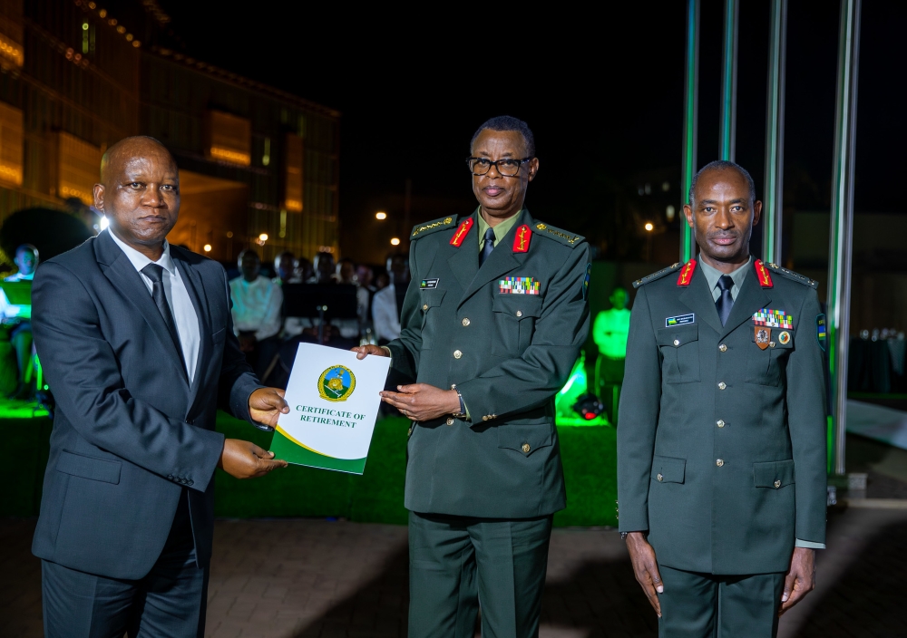Minister of Defence Juvenal Marizamunda hands over a certicificate of retirement to Gen James Kabarebe as Lt Gen Mubarakh Muganga, Chief of Defence Staff looks on. Courtesy