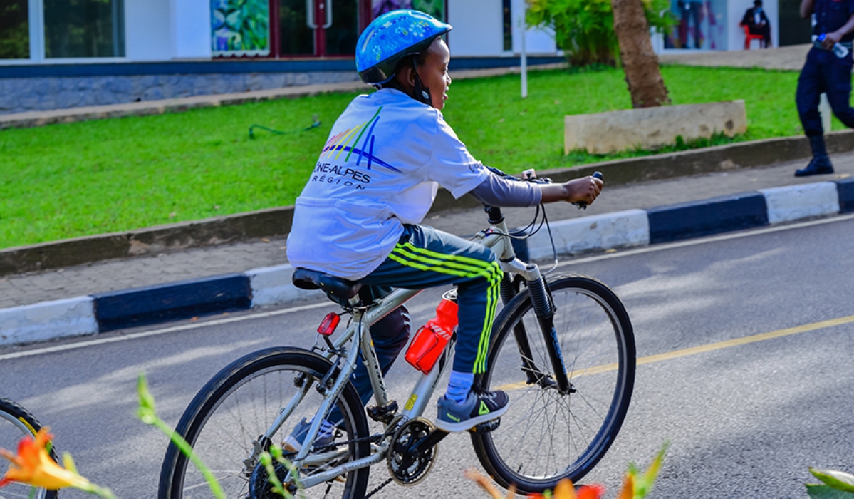 A child rides a bicycle during Car Free Day in Kigali.