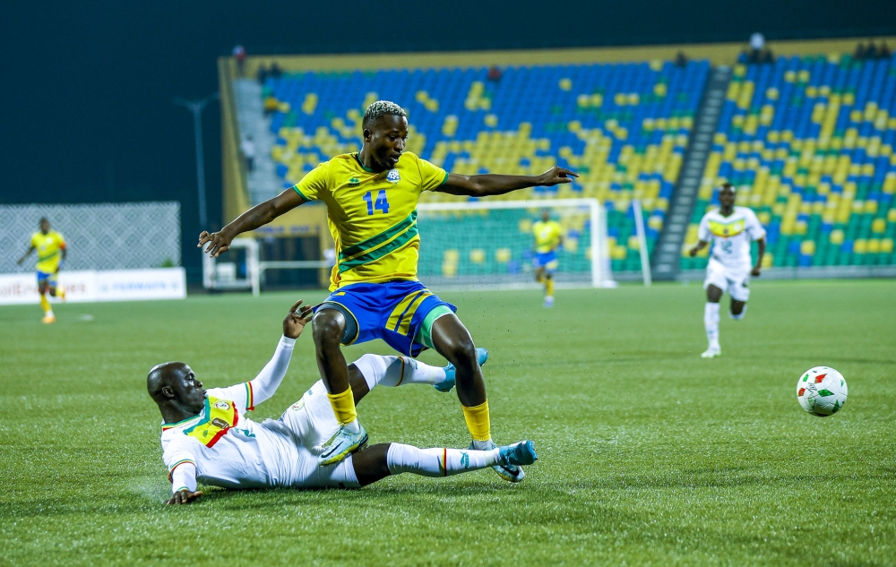 National football team striker Lague Byiringiro wins the ball against Senegalese defender on September 9. Photo by Olivier Mugwiza