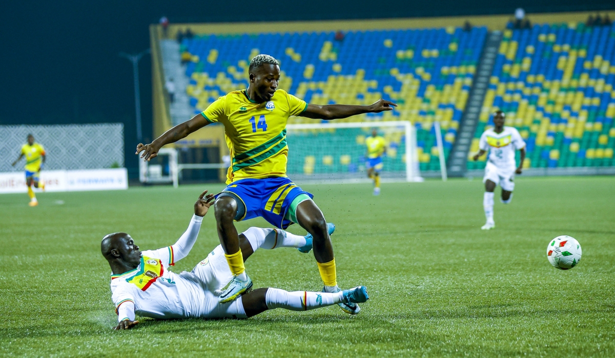 National football team striker Lague Byiringiro wins the ball against Senegalese defender on September 9. Photo by Olivier Mugwiza