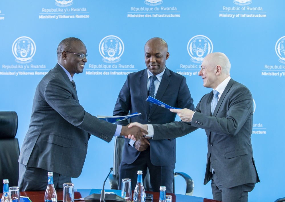 Minister of Infrastructure Ernest Nsabimana (c) looks on as Dual Fluid President and Chairman, Armin Huke (right), shakes hands with the Rwanda Atomic Energy Board (RAEB) CEO Fidel Ndahayo after the signing ceremony on Tuesday, September 12, in Kigali. COURTESY
