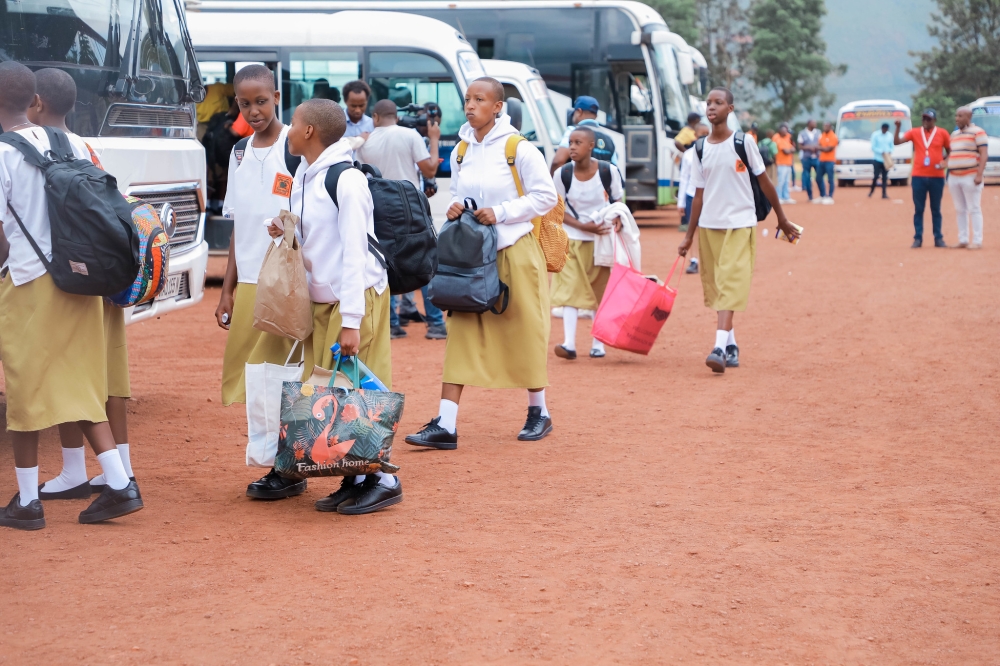 Students  board buses on their way back to school for the third time at Kigali Stadium. Photo by Craish Bahizi.