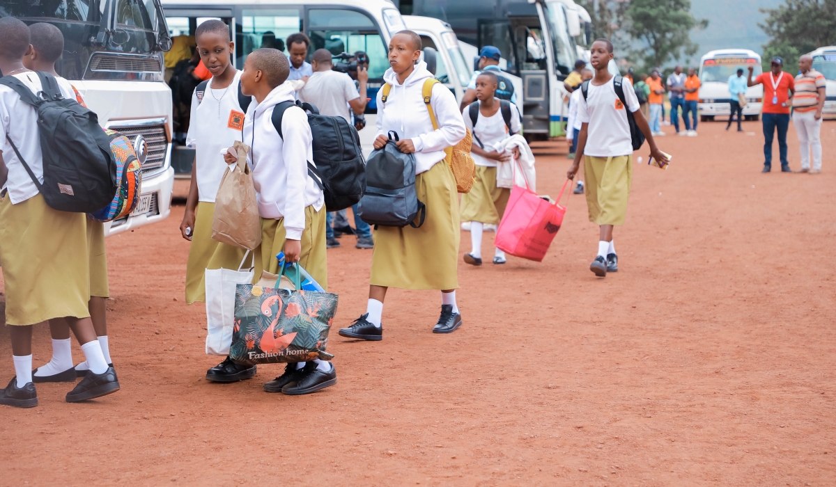 Students  board buses on their way back to school for the third time at Kigali Stadium. Photo by Craish Bahizi.