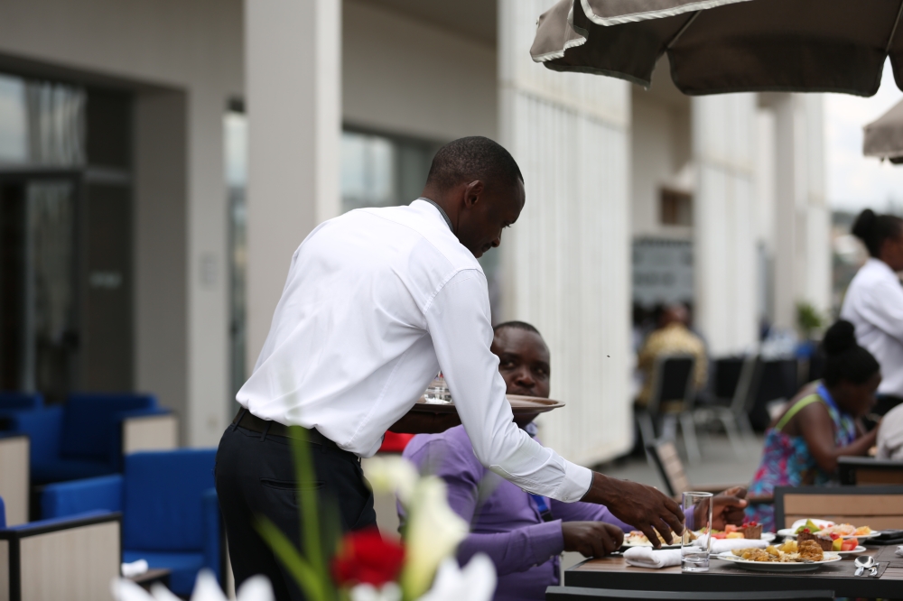 A waiter serves a client at Onomo Hotel in Kigali. File