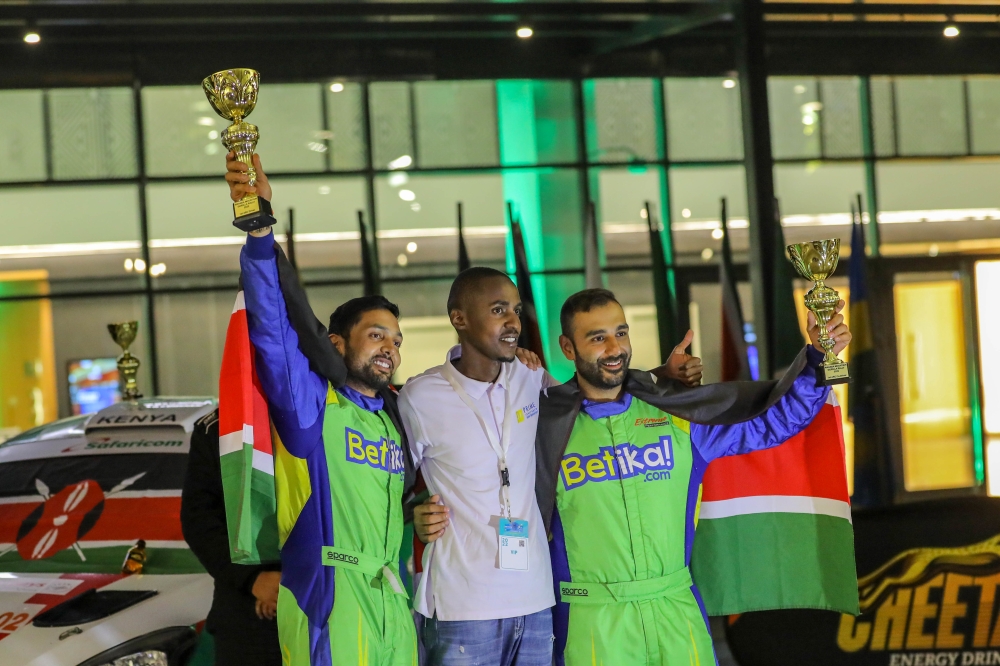 Kenyan driver Karan Patel and his co-driver with the trophies after winning the 2022 Rwanda Mountain Gorilla Rally in Bugesera.