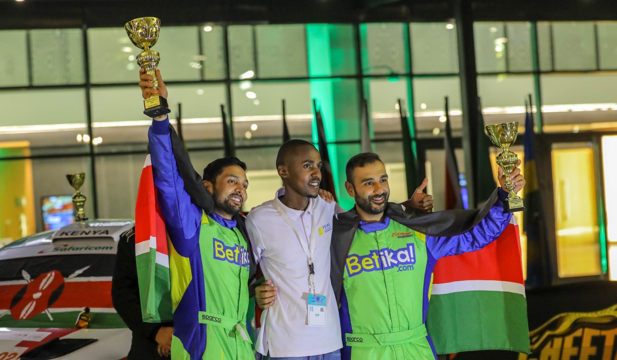 Kenyan driver Karan Patel and his co-driver with the trophies after winning the 2022 Rwanda Mountain Gorilla Rally in Bugesera.