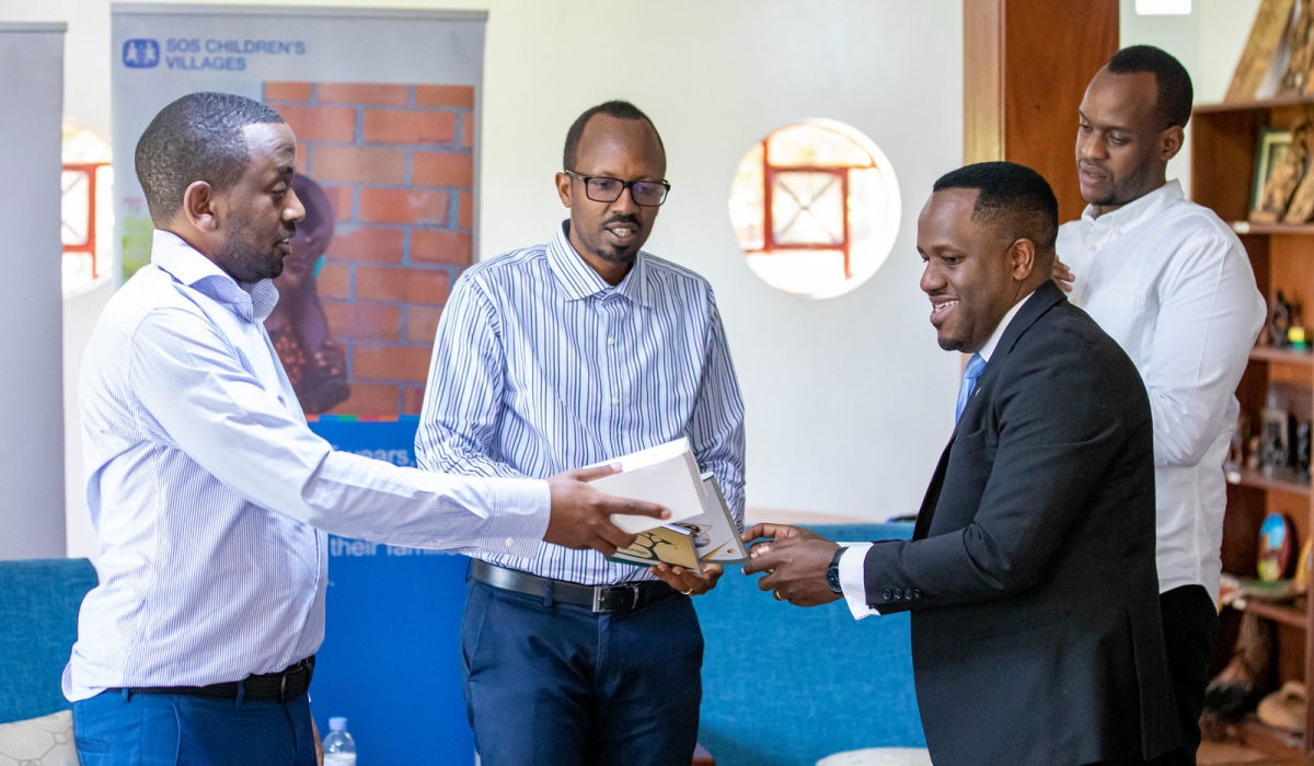 Antoine Iyamuremye, Head of Marketing and Product Development at Cogebanque Plc hands over the donation to Jean Bosco Kwizera, the National Director of SOS Children’s Villages in Rwanda. Photos by Dan Gatsinzi