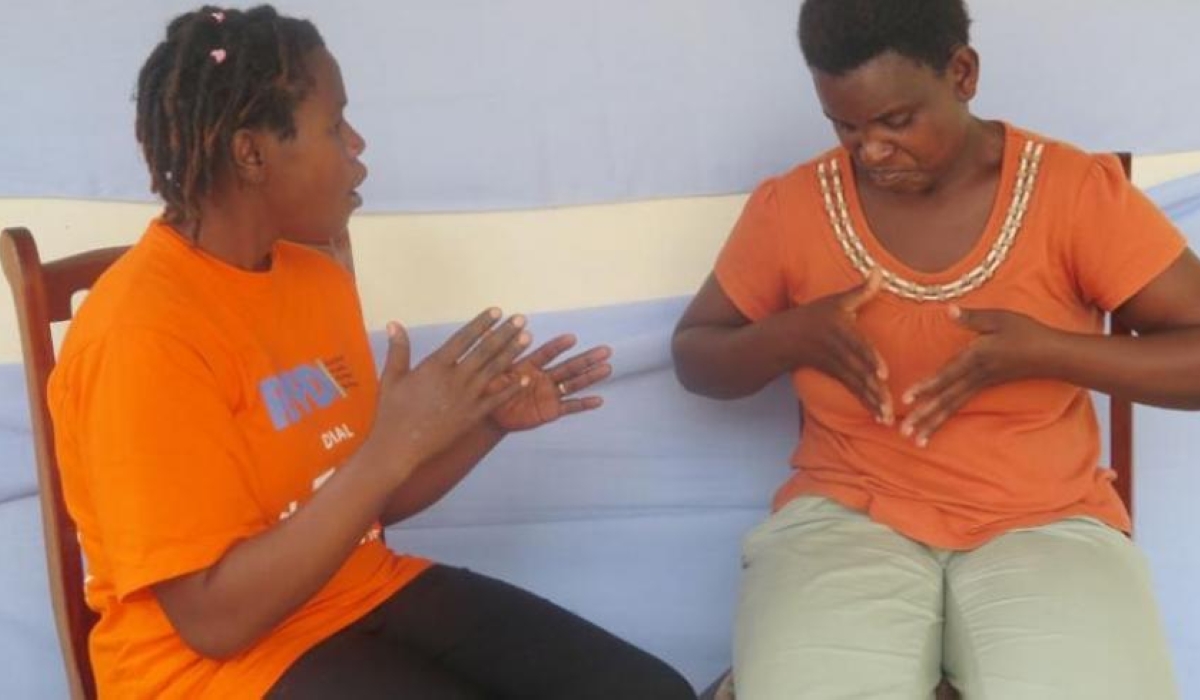 Two ladies during interact through sign language in Muhanga District .Photo by Emmanuel Ntirenganya