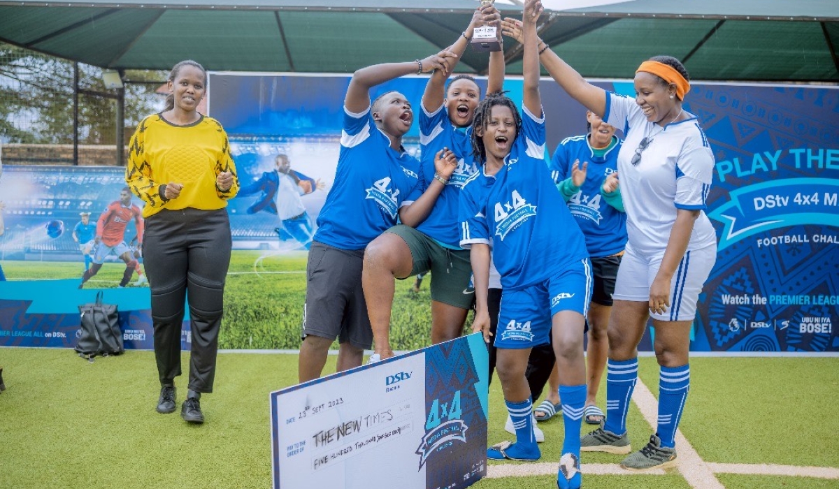 The New Times’ women football team lift the trophy to celebrate the vistory as they clinch the DStv 4x4 Media Football Challenge title on Saturday. Courtesy