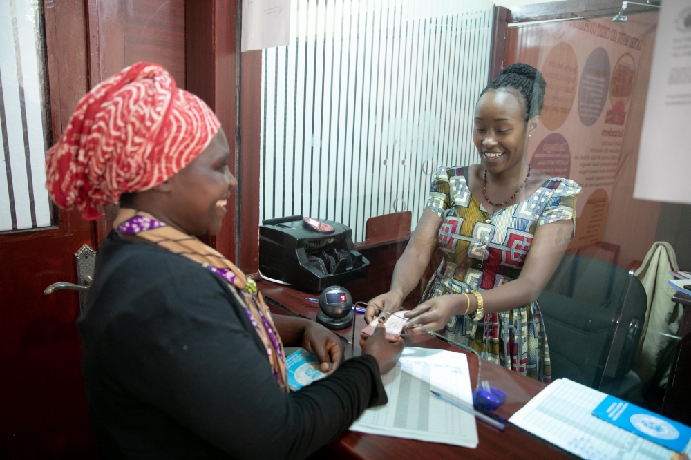 A women recieves the money at Umurenge SACCO Kacyiru. Rwanda&#039;s financial inclusion is at 77 per cent. Craish Bahizi