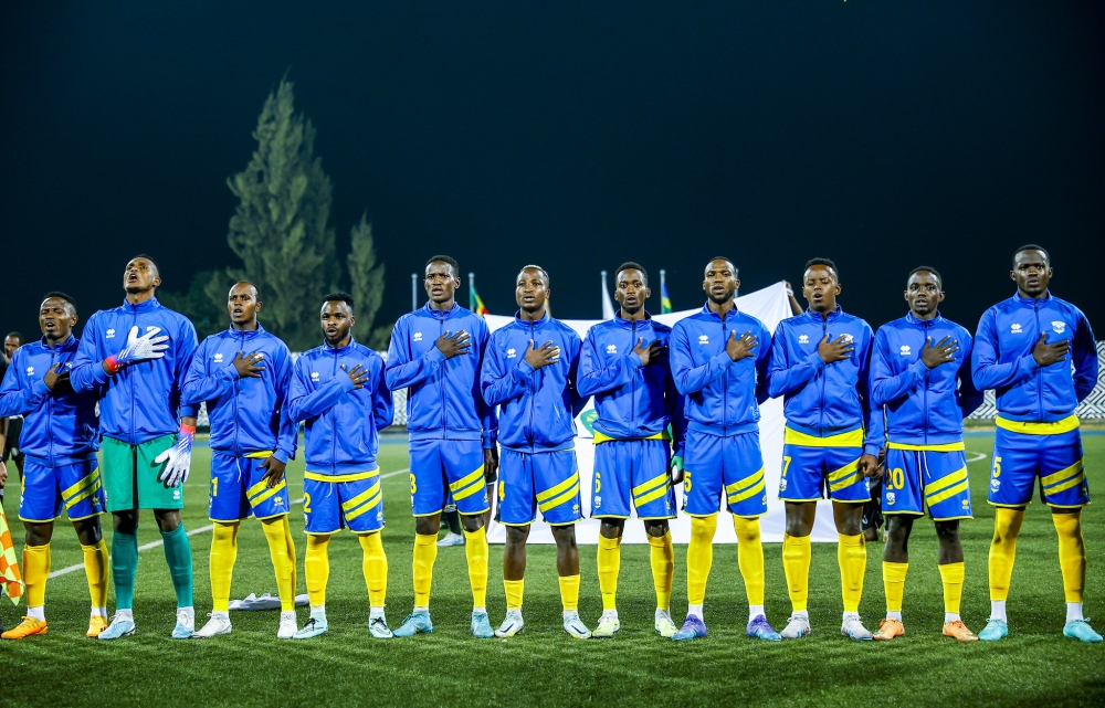 National football team players sing the national anthem before facing Senegal at Huye Stadium. Photo by Olivier Mugwiza