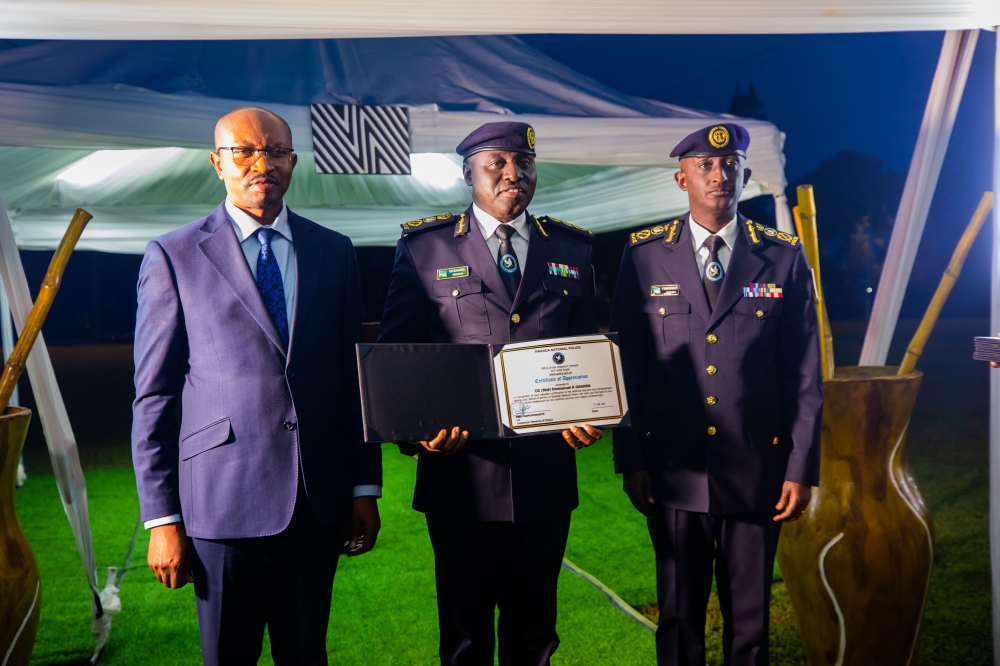 Former Inspector General of Police Emmanuel Gasana receiving a certificate of service from Minister of Interior Alfred Gasana as IGP Felix Namuhoranye looks on, on Friday, September 29.