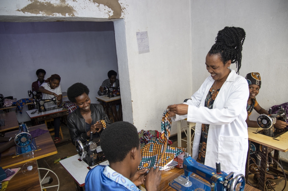 Niyomugenga&#039;s mother Chantal Mukasharangabo during a training session of tailors . She  is one of one of trainers at the school.