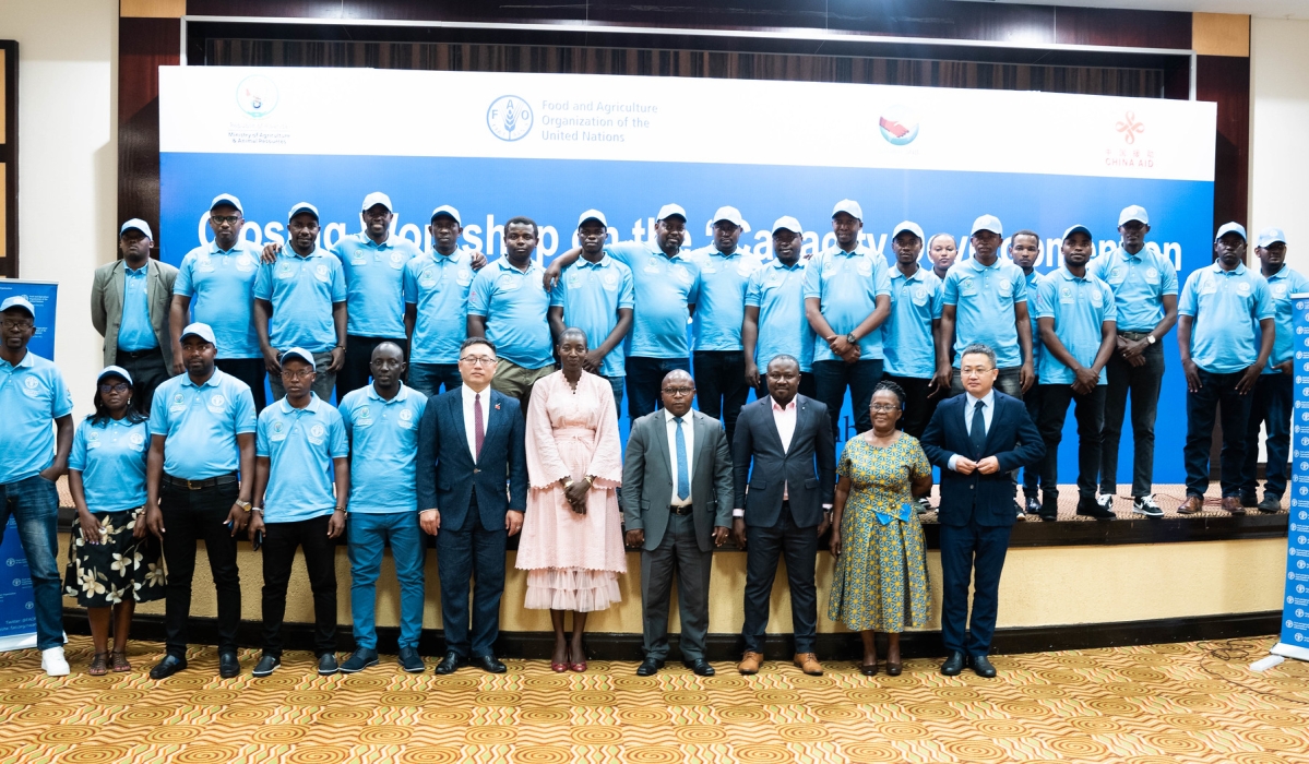 Officials and participants pose for a group photo during the closing workshop on the project in Kigali, on September 29. Craish Bahizi