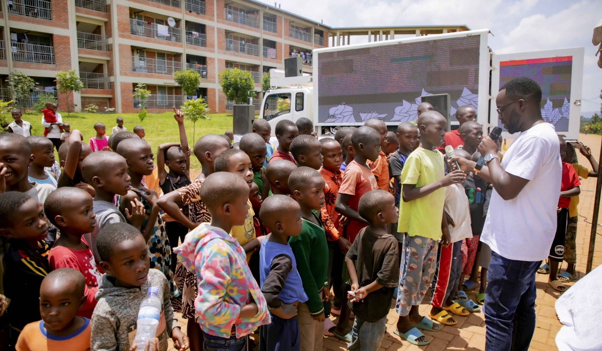 Isaie Micomyiza, Ubongo&#039;s Country Manager in Rwanda interacts with children during the campaign at Karama model village in Nyarugenge on Saturday, September 30. The campaign aims to celebrate knowledge, promote digital literacy, and make learning fun. 