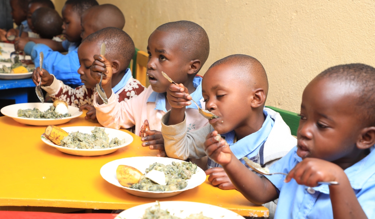 Children eat nutritious food at early childhood development centre in Nyamasheke District. Photo by Craish Bahizi