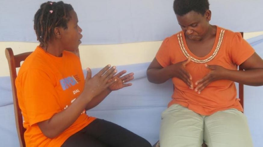 Two ladies during interact through sign language in Muhanga District .Photo by EmmanuelNtirenganya