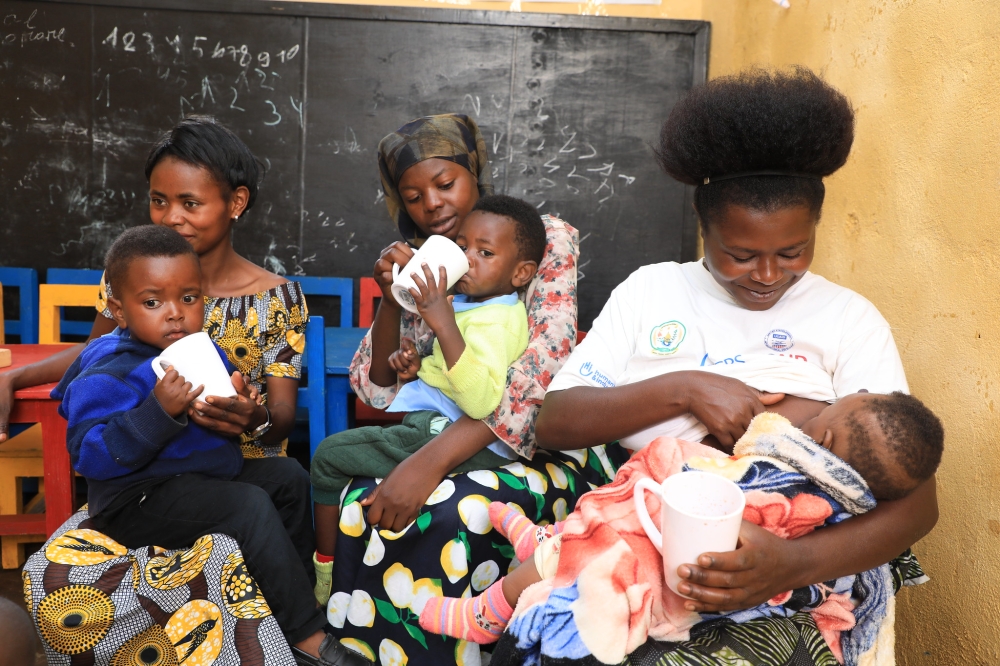 Parents feed their children at an early childhood development centre in Nyamasheke. Insufficient nutrition during this crucial period can result in long-term health implications, such as stunted growth, weakened immune systems, and poor cognitive development. PHOTO BY CRAISH BAHIZI