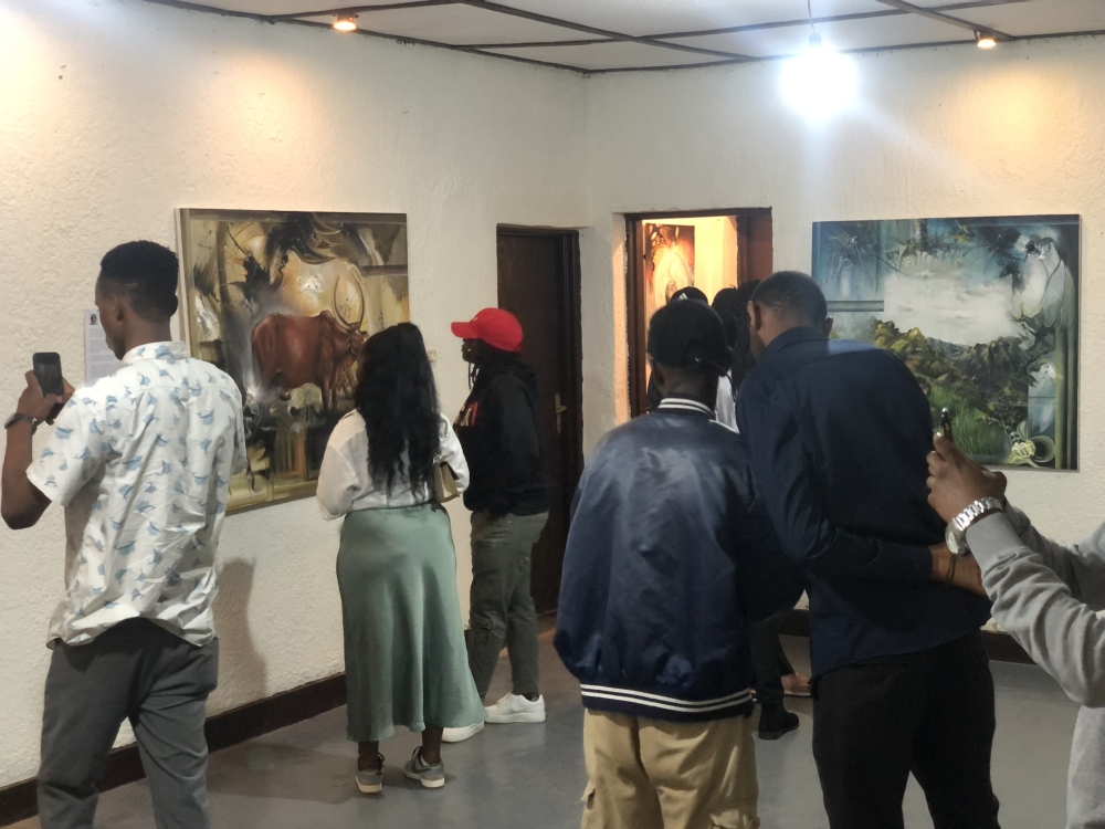 Attendants while viewing the paintings at the Heritage art exhibition at Neza-h art Space-Kiyovu.  Courtesy photos. 