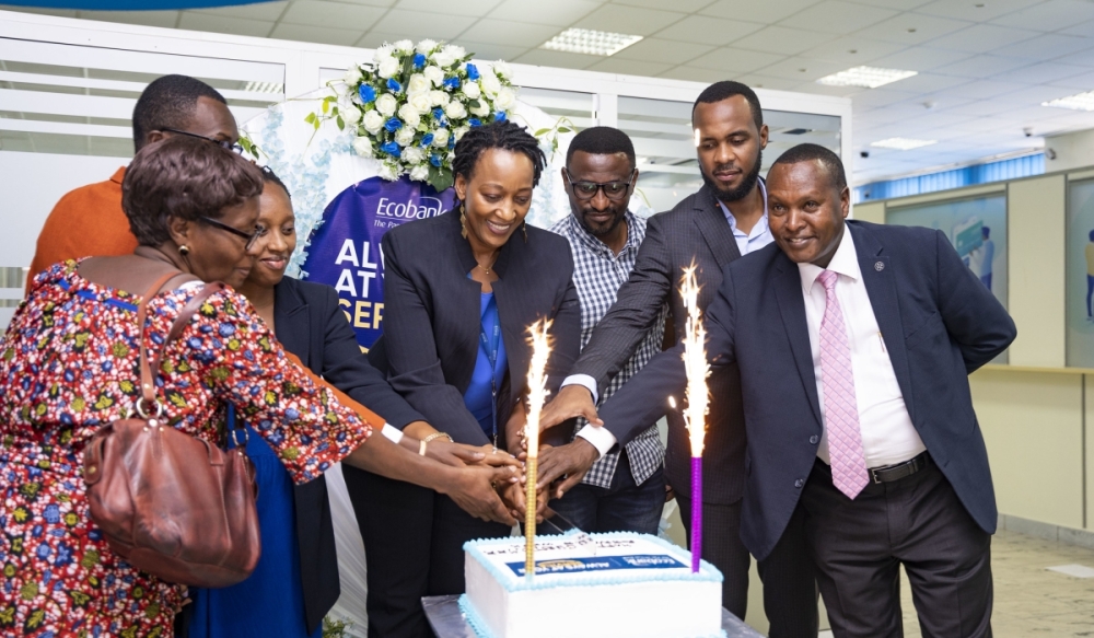 Ecobank Rwanda officials and customers cut a cake to launch Customer Service Week on Monday, October 2 . Photo by Emmanuel Dushimimana_The New Times