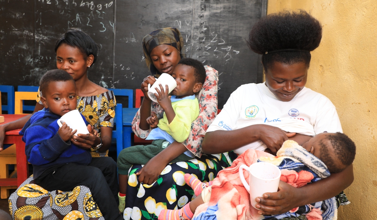 Parents feed their children at an early childhood development centre in Nyamasheke. Insufficient nutrition during this crucial period can result in long-term health implications, such as stunted growth, weakened immune systems, and poor cognitive development. PHOTO BY CRAISH BAHIZI