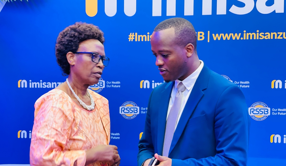 RSSB CEO Régis Rugemanshuro chats with the president of Rwanda Pensioners’ Association, Dorothée Uwimana, during the launch of Imisanzu on January 31, 2023, in Kigali. EMMANUEL NTIRENGANYA
